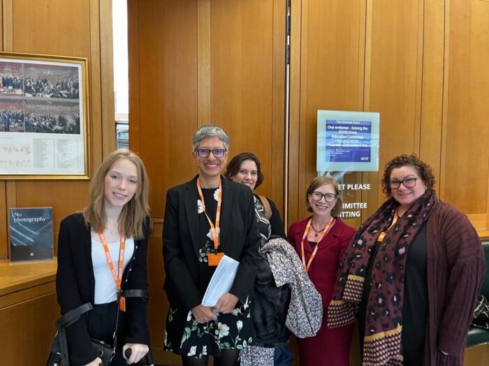 group of five women smiling in Parliament